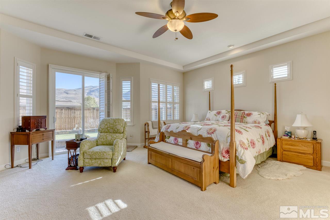 10040 Burghley Lane Reno, NV 89521 - Photo 23 of 39 a bed room with a bed and a couch