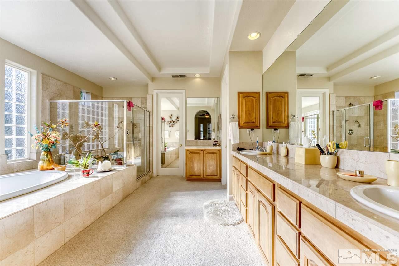 10040 Burghley Lane Reno, NV 89521 - Photo 27 of 39 a large white kitchen with a large window and stainless steel appliances