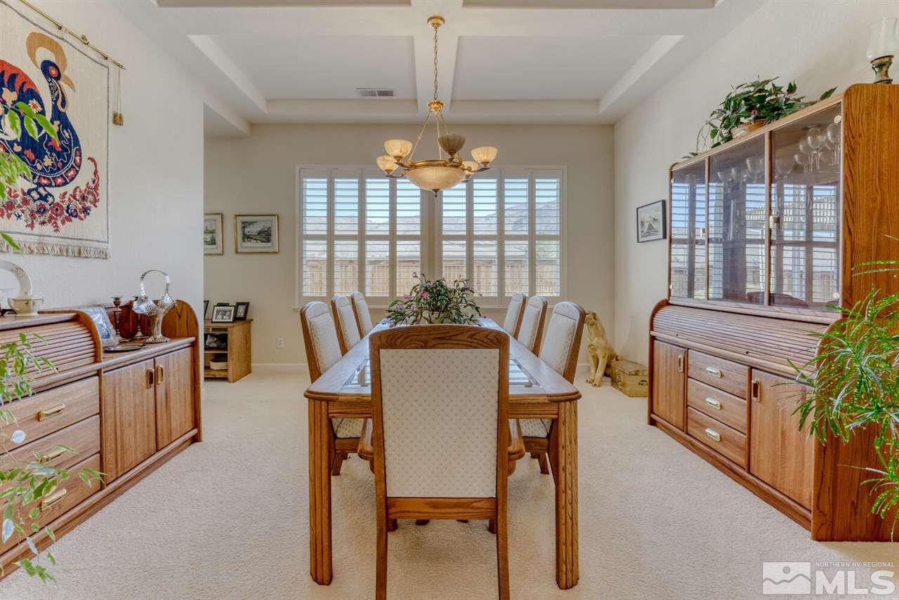 10040 Burghley Lane Reno, NV 89521 - Photo 8 of 39 a view of a dining room with furniture a chandelier and window