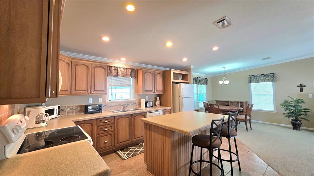 36740 Strand Drive Zephyrhills, FL 33542 - Photo 14 of 74 a kitchen with a sink a counter top space and stainless steel appliances