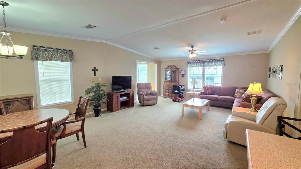 36740 Strand Drive Zephyrhills, FL 33542 - Photo 17 of 74 a living room with furniture and a flat screen tv