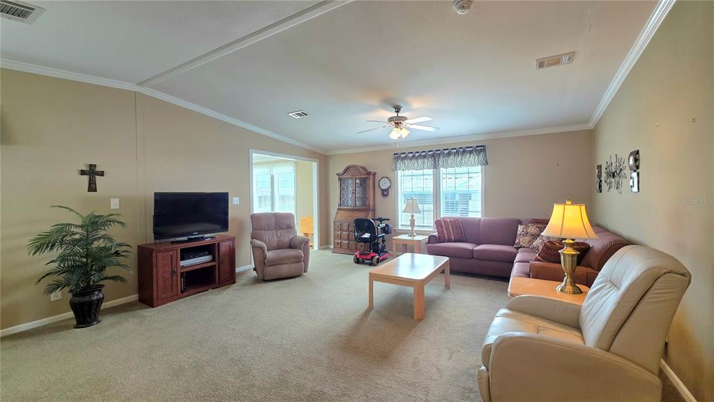 36740 Strand Drive Zephyrhills, FL 33542 - Photo 21 of 74 a living room with furniture and a flat screen tv