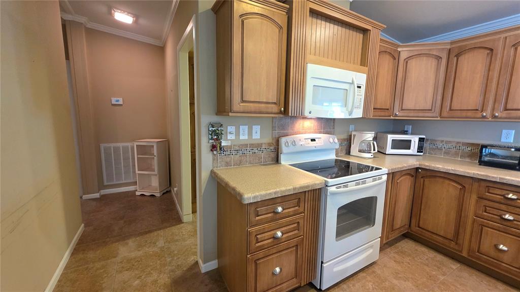 36740 Strand Drive Zephyrhills, FL 33542 - Photo 29 of 74 a kitchen with a stove sink and cabinets