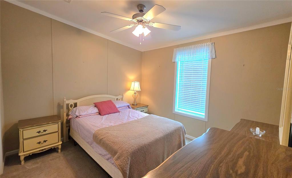 36740 Strand Drive Zephyrhills, FL 33542 - Photo 34 of 74 a bedroom with a bed and a night stand