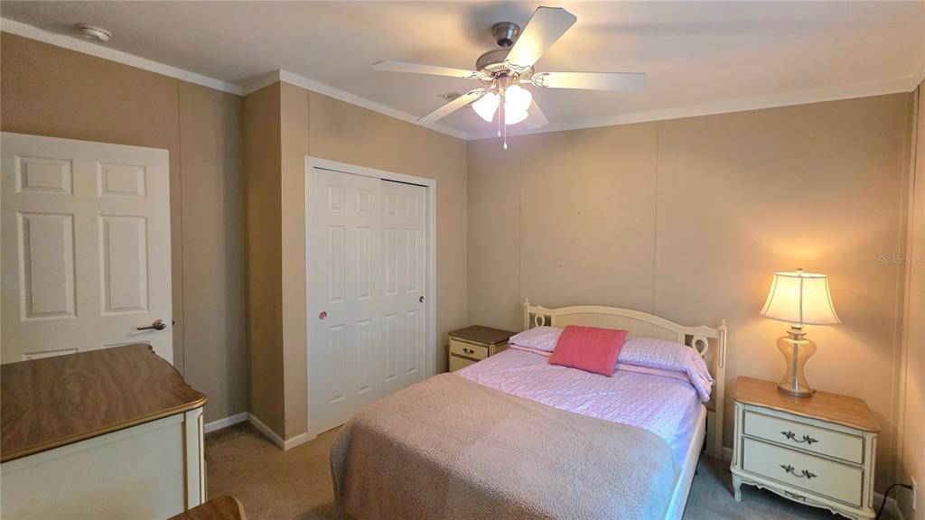 36740 Strand Drive Zephyrhills, FL 33542 - Photo 35 of 74 a bedroom with a bed and a chandelier