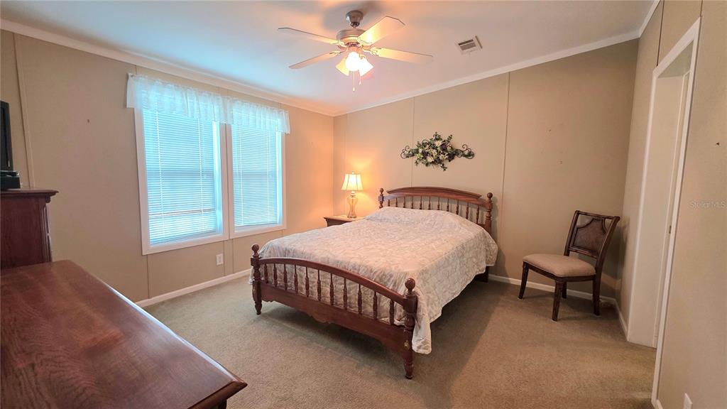 36740 Strand Drive Zephyrhills, FL 33542 - Photo 37 of 74 a spacious bedroom with a bed and a window