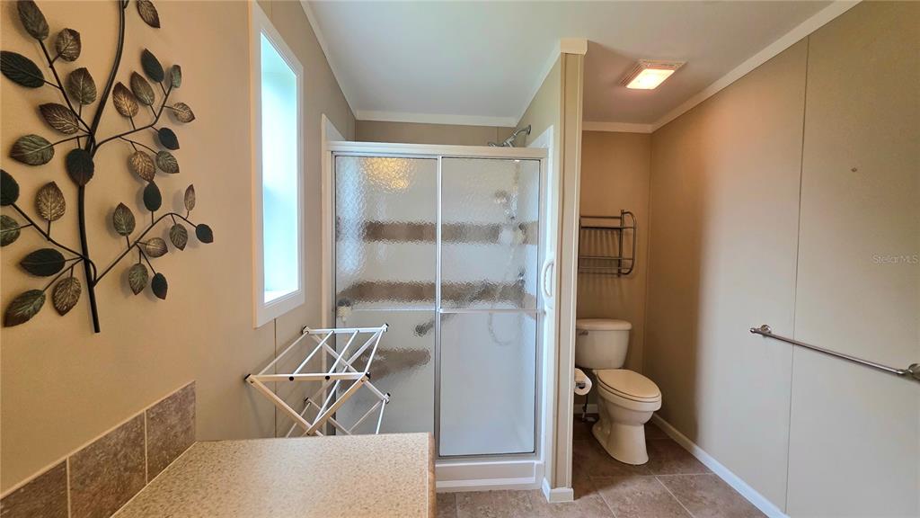36740 Strand Drive Zephyrhills, FL 33542 - Photo 42 of 74 a bathroom with a toilet and a shower