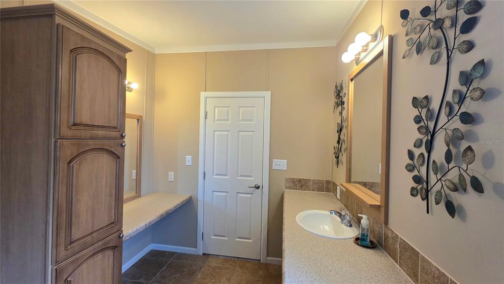 36740 Strand Drive Zephyrhills, FL 33542 - Photo 43 of 74 a bathroom with a sink a toilet and shower