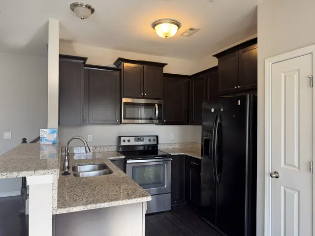 a kitchen with a sink a stove and refrigerator