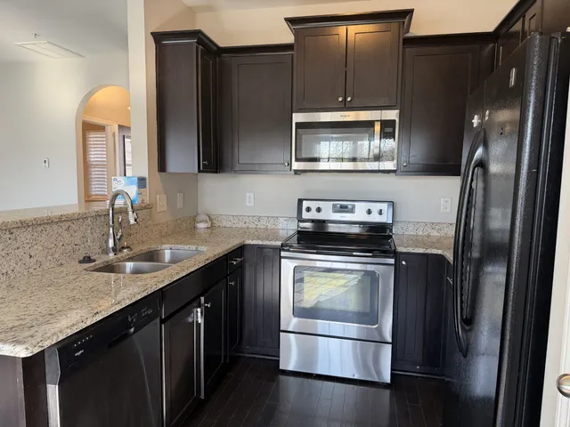 a kitchen with a sink and a refrigerator