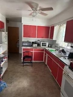 a kitchen with stainless steel appliances granite countertop a sink stove and cabinets