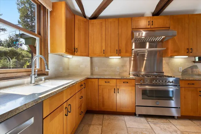 a kitchen with a sink stove and cabinets