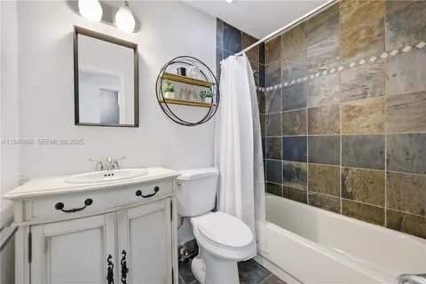 a bathroom with a sink mirror toilet and bathtub