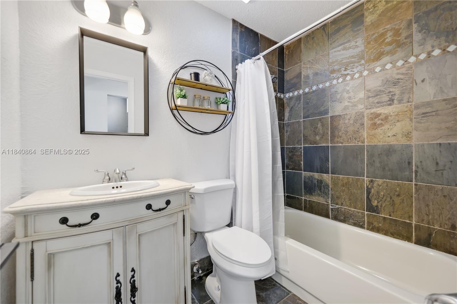 19654 Back 9 Drive Boca Raton, FL 33498 - Photo 15 of 35 a bathroom with a sink mirror toilet and bathtub