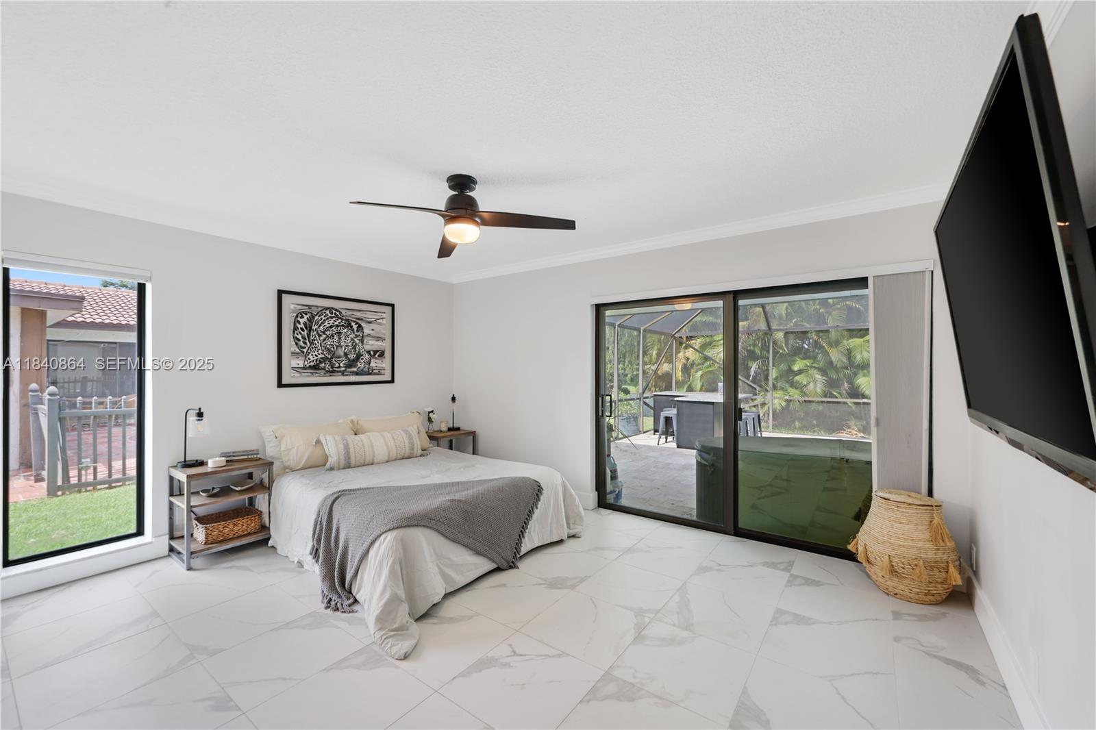 19654 Back 9 Drive Boca Raton, FL 33498 - Photo 16 of 35 a bedroom with a bed and a flat tv screen