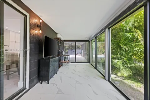 a view of a living room hardwood floor and a large window