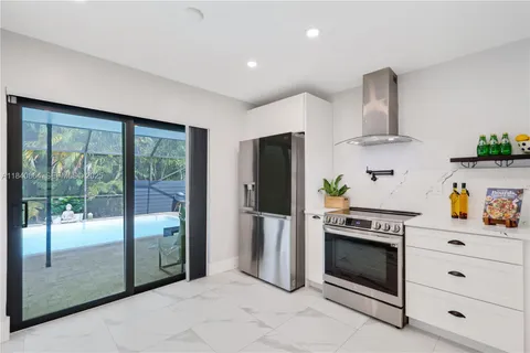 a kitchen with stainless steel appliances a stove a refrigerator and a cabinets