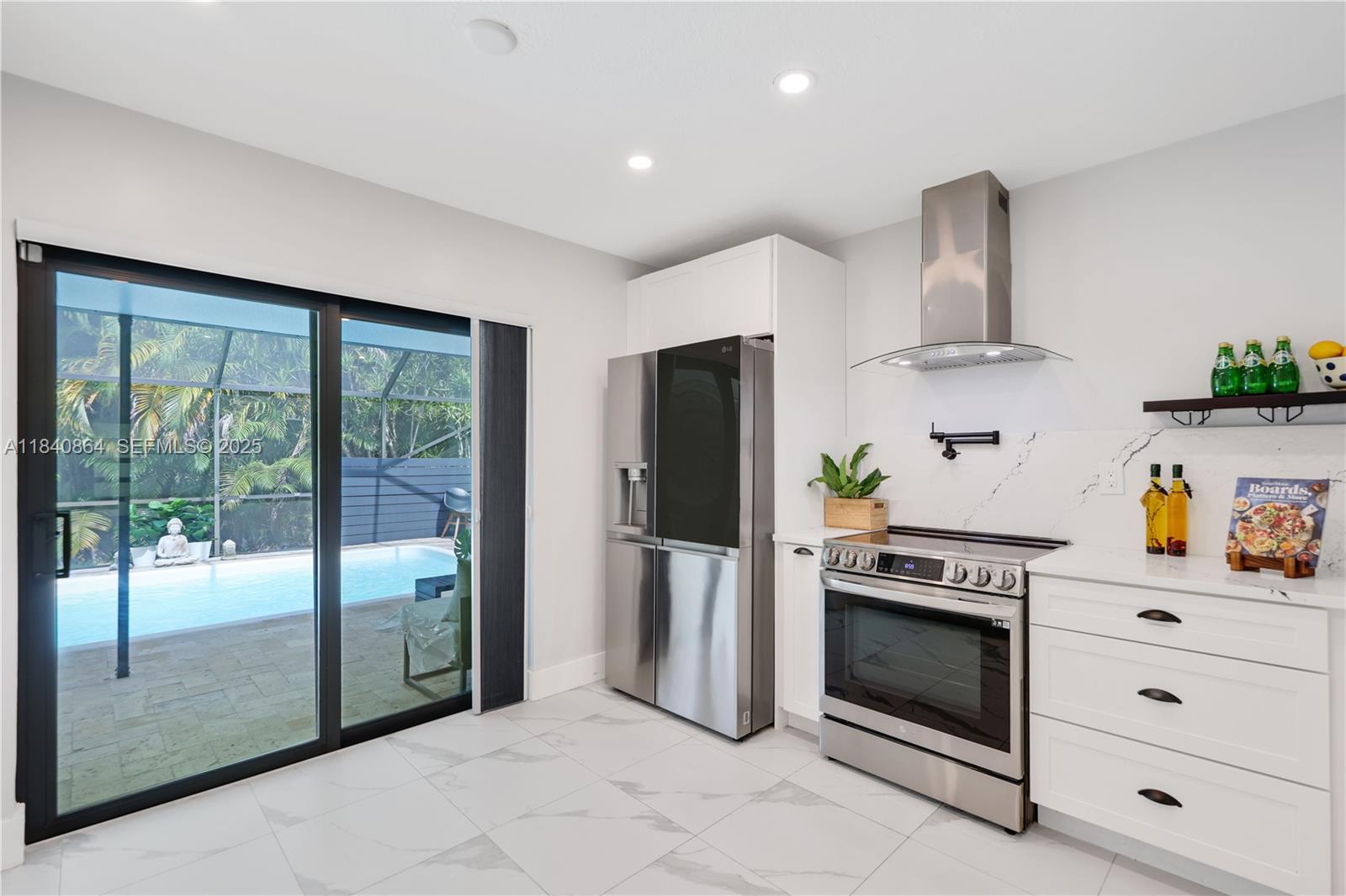 19654 Back 9 Drive Boca Raton, FL 33498 - Photo 9 of 35 a kitchen with stainless steel appliances a stove a refrigerator and a cabinets