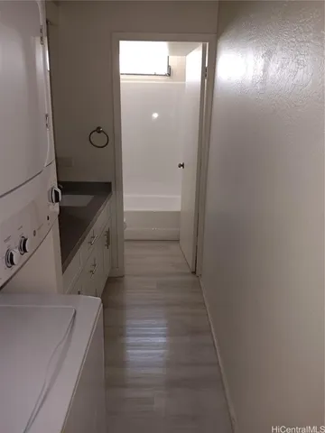 a bathroom with a granite countertop sink a mirror and shower
