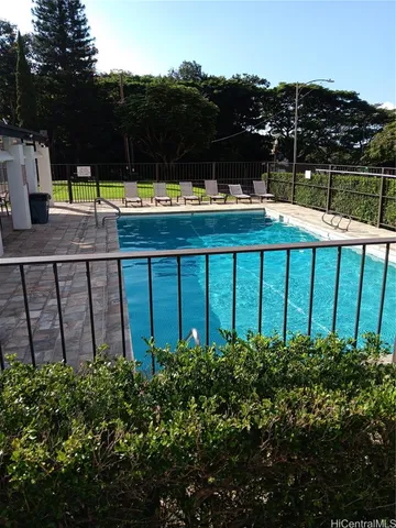 a view of a chairs and table in the backyard