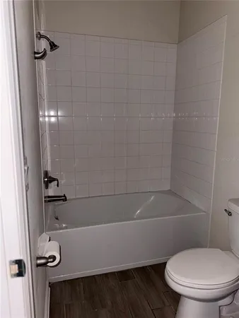 a bathroom with a toilet a sink and bathtub