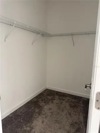 a view of a big room with a ceiling fan