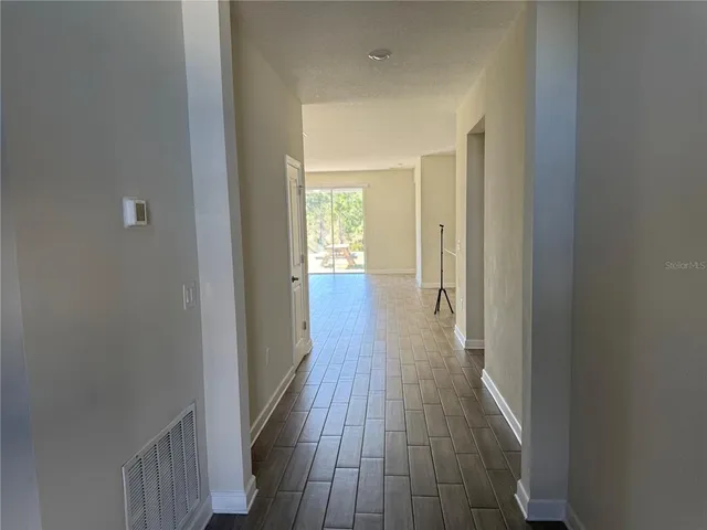 an empty room with a ceiling fan and carpet