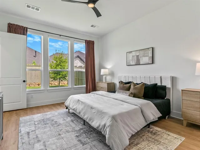 a bedroom with a large bed and a window