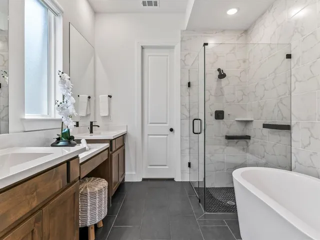 a bathroom with a granite countertop sink a toilet a mirror and shower