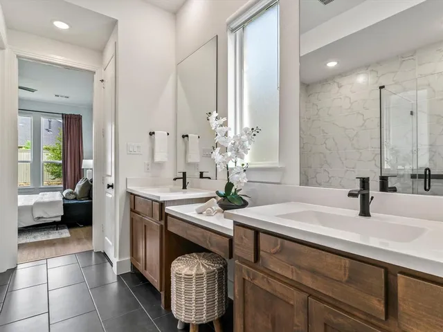 a spacious bathroom with a sink double vanity and a mirror