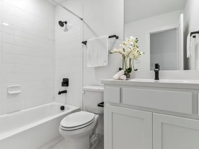 an empty room with a ceiling fan and window