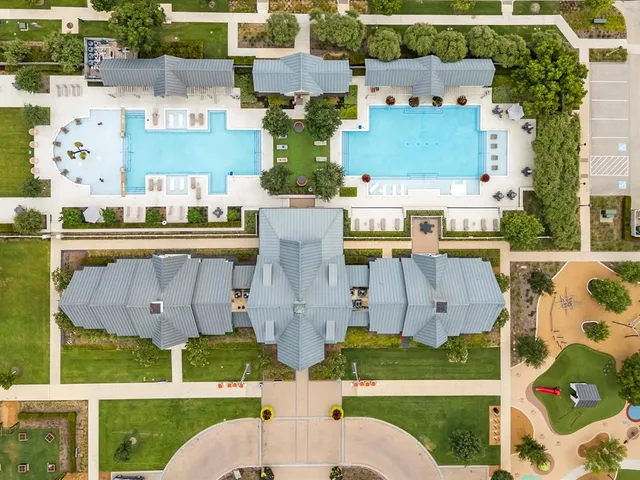 a front view of a house with lots of potted plants