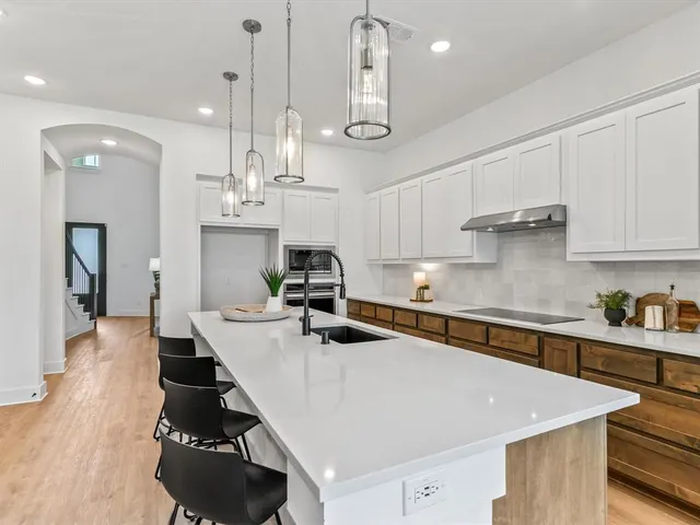 a large kitchen with stainless steel appliances lots of counter space and breakfast area