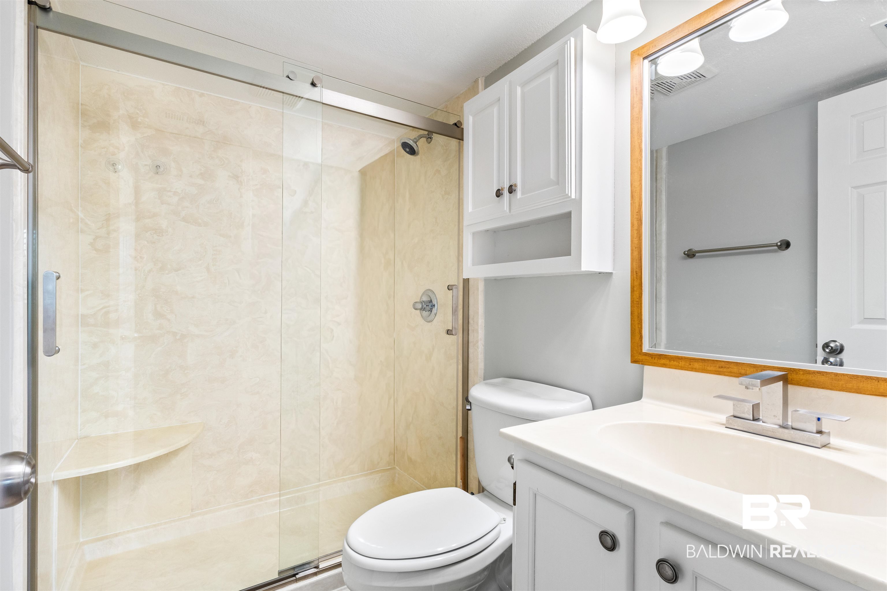 25861 Canal Road, Unit 3 Orange Beach, AL 36561 - Photo 16 of 40 Bathroom featuring vanity and a stall shower