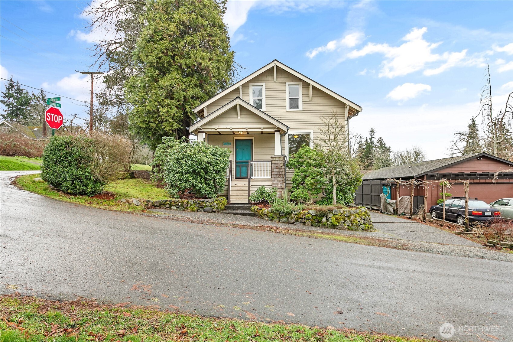 a front view of a house with a yard and trees