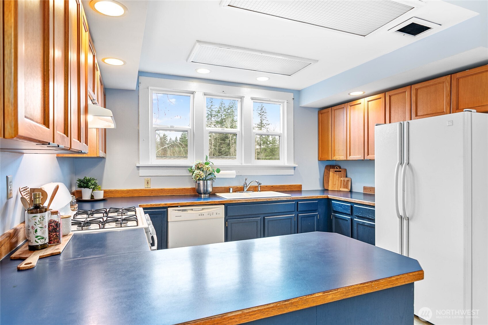 3820 Ohio Street Bellingham, WA 98229 - Photo 9 of 40 a large kitchen with kitchen island a large window cabinets and stainless steel appliances