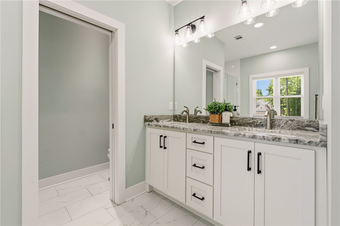 502 Canebrake Drive Anderson, SC 29621 - Photo 24 of 39 This serene bathroom features a spacious double vanity with ample storage and elegant finishes.
