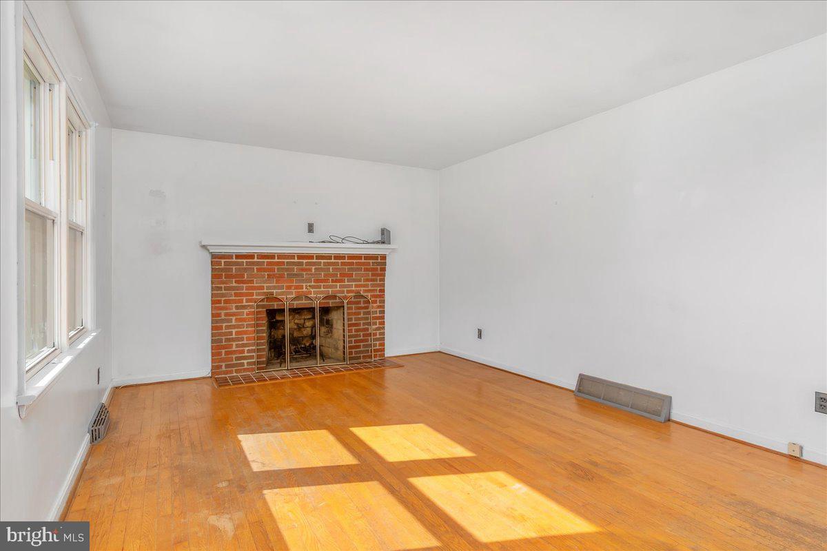 13806 Wolfsville Road Smithsburg, MD 21783 - Photo 7 of 35 a view of an empty room with a fireplace and a window
