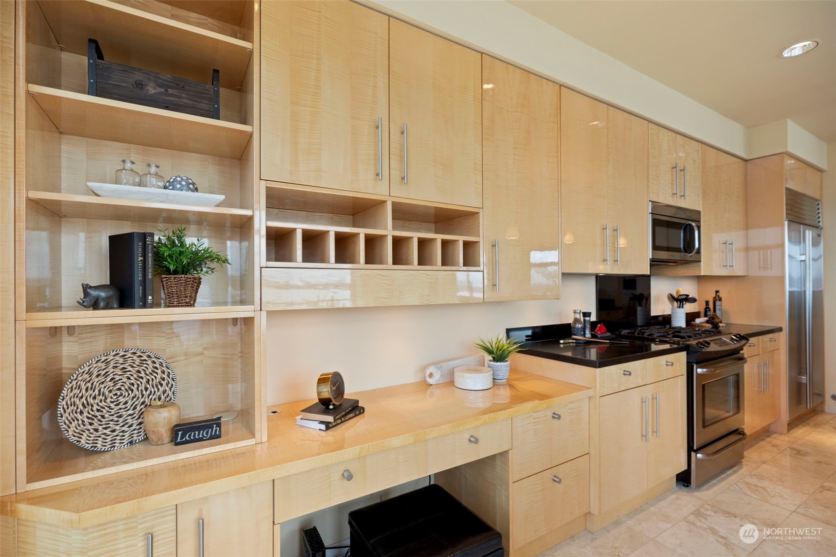 1900 Alaskan Way, Unit 516 Seattle, WA 98101 - Photo 13 of 40 a kitchen with stainless steel appliances a sink a stove a microwave a sink and cabinets