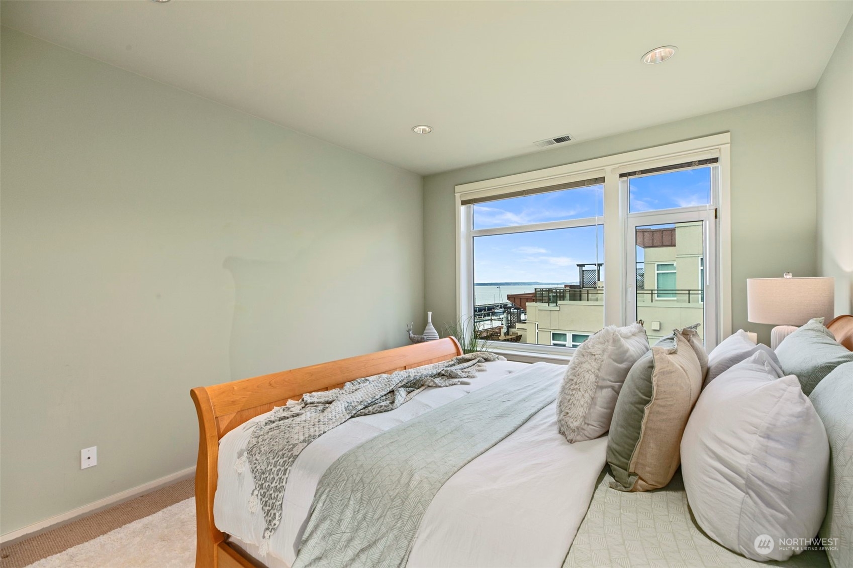 1900 Alaskan Way, Unit 516 Seattle, WA 98101 - Photo 17 of 40 a bed sitting in a bedroom next to a window