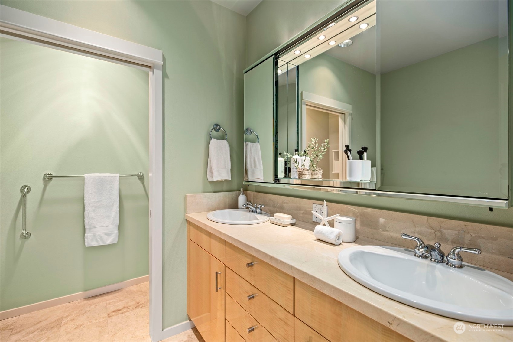 1900 Alaskan Way, Unit 516 Seattle, WA 98101 - Photo 20 of 40 a bathroom with a double vanity sink and mirror