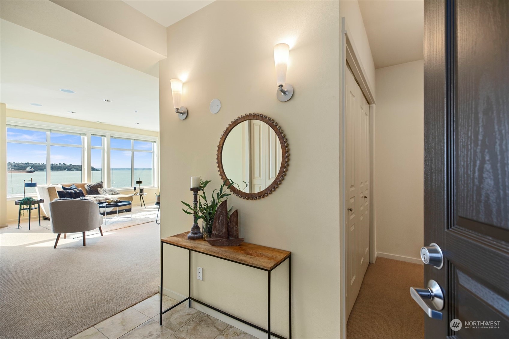 1900 Alaskan Way, Unit 516 Seattle, WA 98101 - Photo 2 of 40 a living room with furniture a mirror and a table