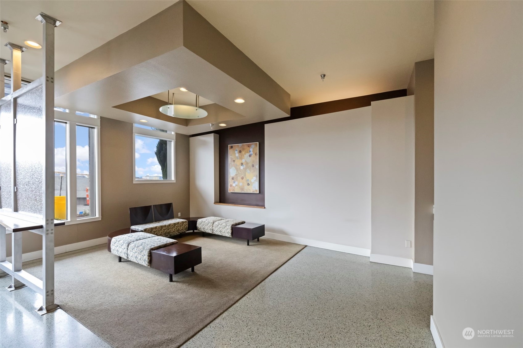 1900 Alaskan Way, Unit 516 Seattle, WA 98101 - Photo 29 of 40 a spacious bedroom with a bed and glass window