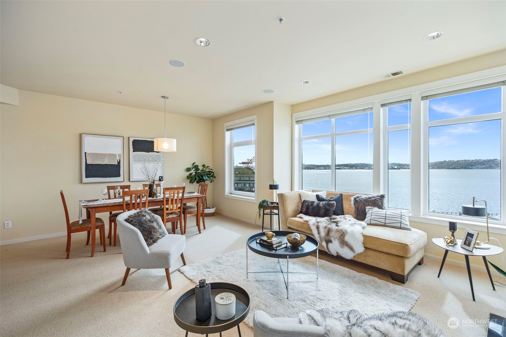 1900 Alaskan Way, Unit 516 Seattle, WA 98101 - Photo 4 of 40 a living room with furniture a large window and a table