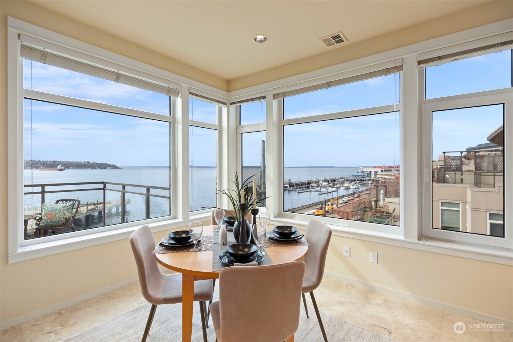 1900 Alaskan Way, Unit 516 Seattle, WA 98101 - Photo 10 of 40 a view of a dining room with furniture large windows and wooden floor