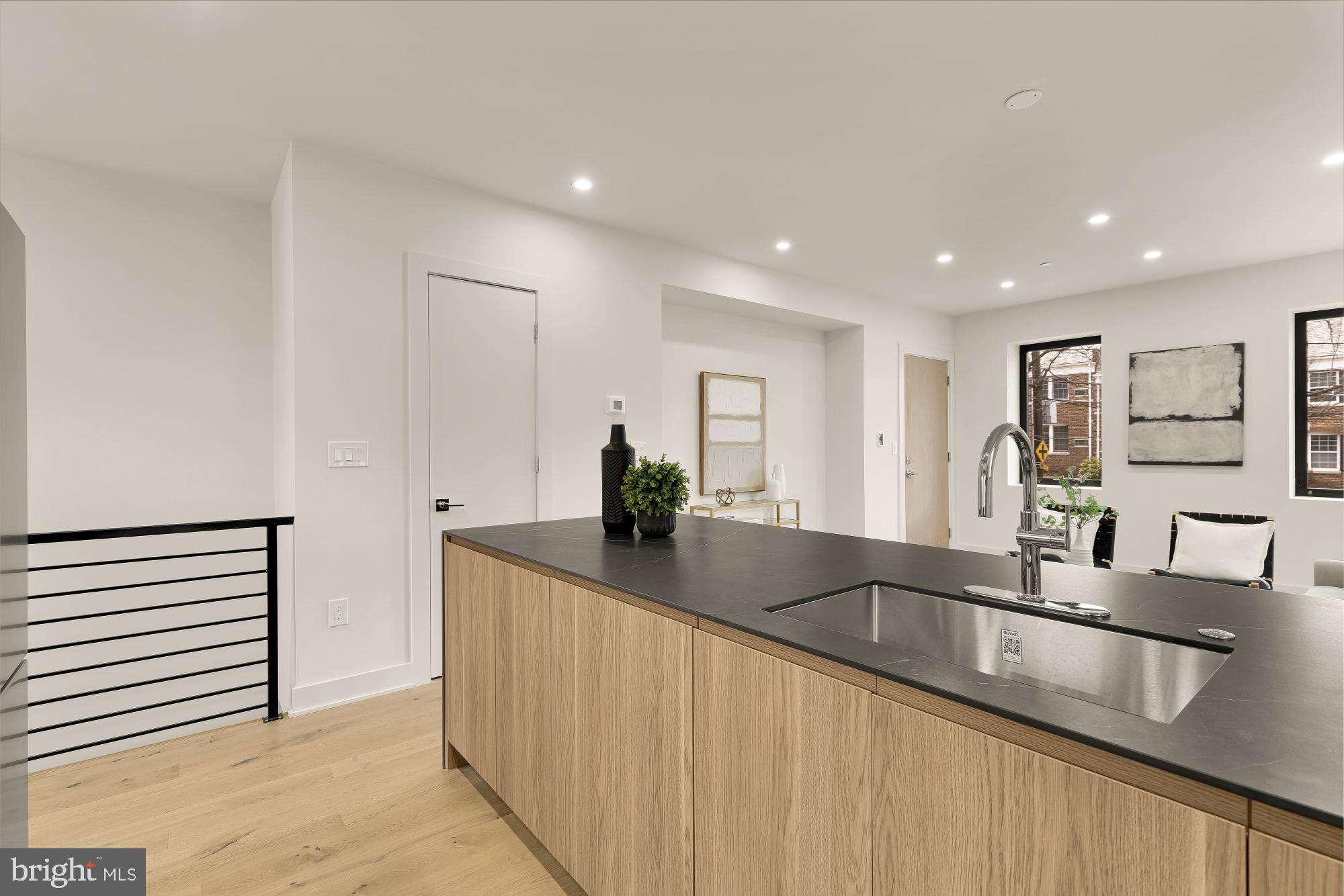 2647 41st Street Northwest, Unit 1 Washington, DC 20007 - Photo 11 of 32 a kitchen with kitchen island a sink and a refrigerator