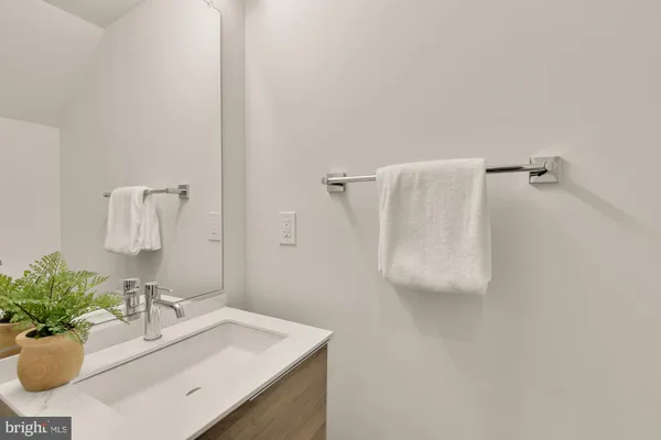 a bathroom with a sink toilet and mirror