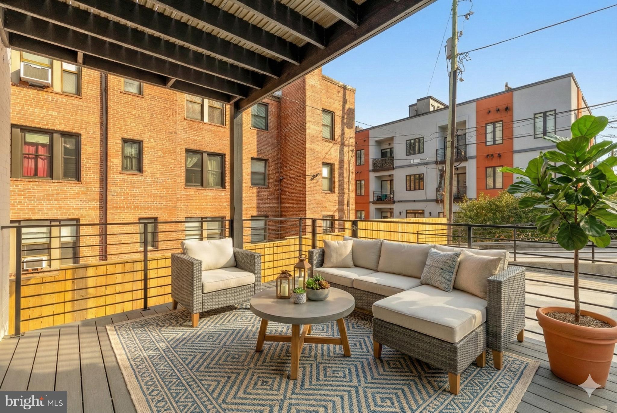 2647 41st Street Northwest, Unit 1 Washington, DC 20007 - Photo 14 of 32 a balcony with furniture and wooden floor
