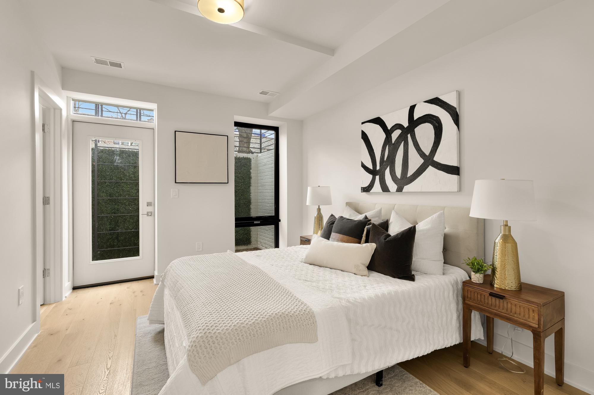 2647 41st Street Northwest, Unit 1 Washington, DC 20007 - Photo 19 of 32 a bedroom with a bed and painting on the wall
