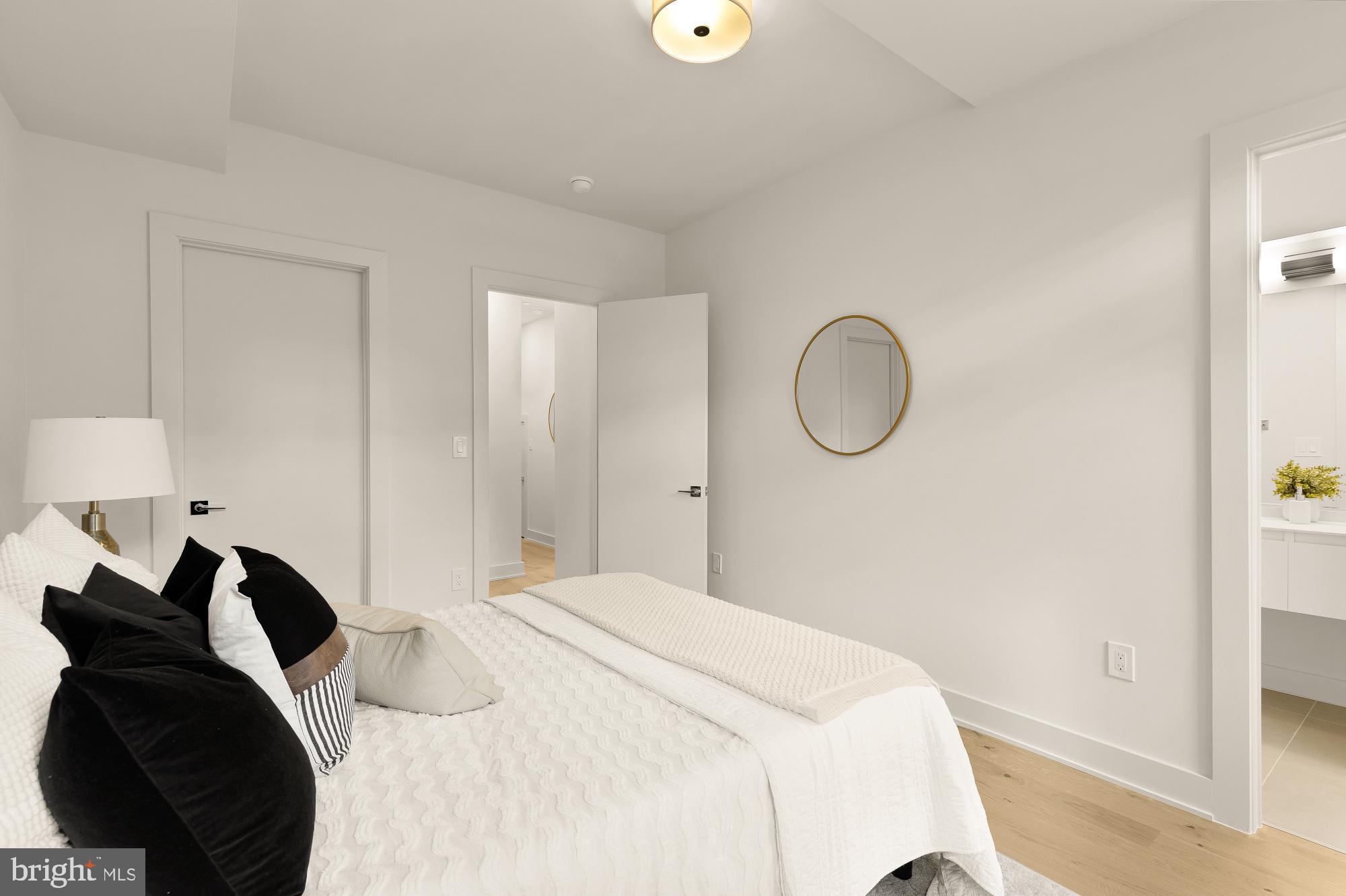 2647 41st Street Northwest, Unit 1 Washington, DC 20007 - Photo 22 of 32 a bedroom with a bed and a mirror